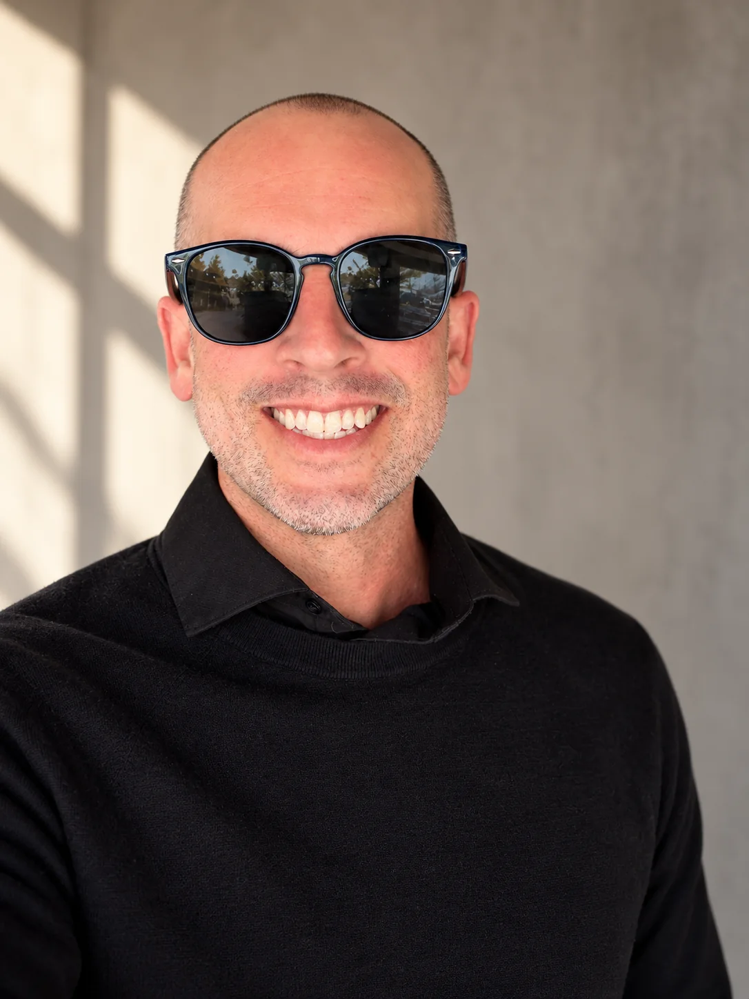 Tyler Barnett in black, wearing sunglasses