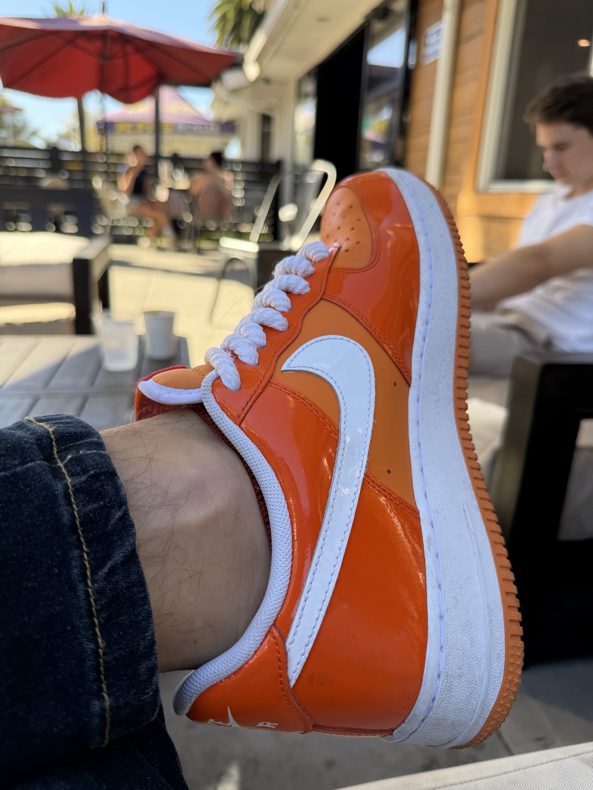 A bright orange sneaker, an everyday detail in Tyler’s visual world